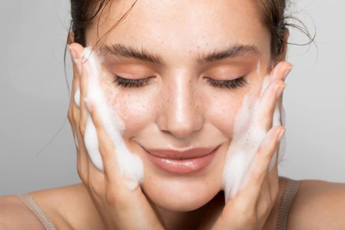 close-up of woman washing her face