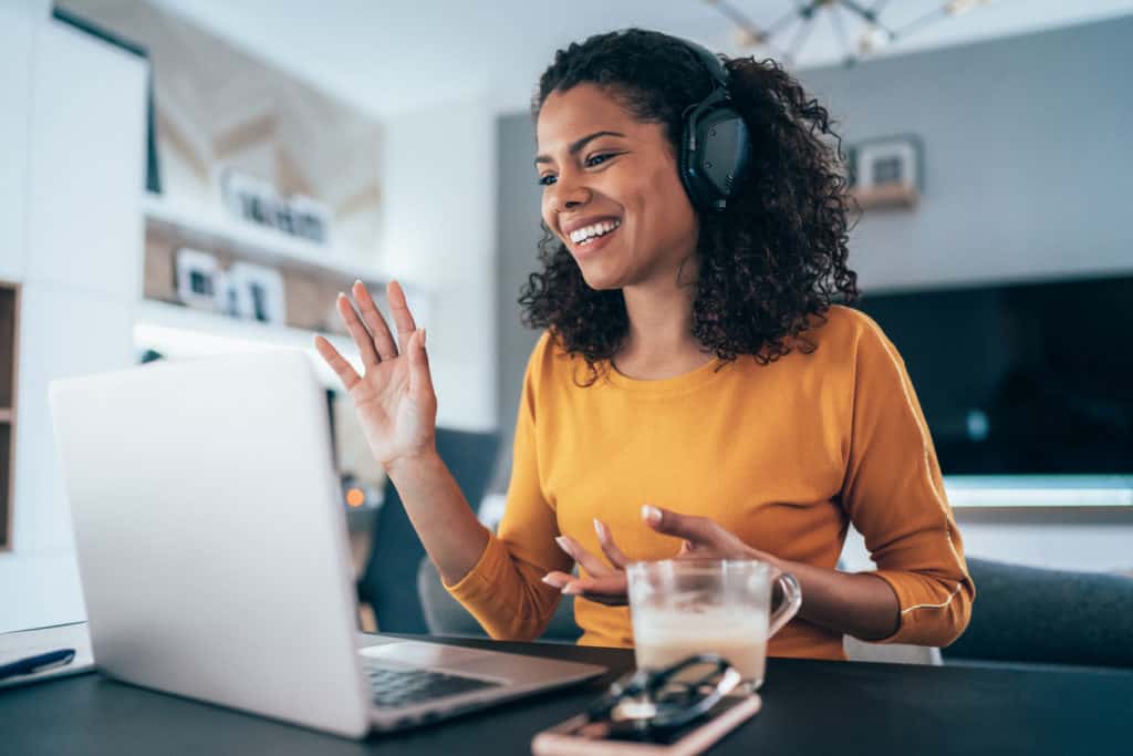 employee waving on conference call working remotely