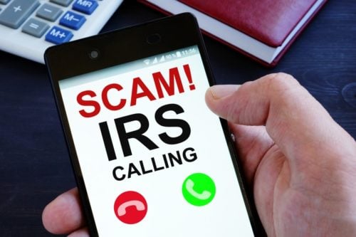 A smartphone screen showing a scam IRS call in progress