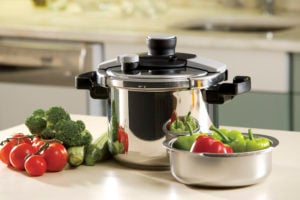 pressure cooker and vegetables sitting on a kitchen countertop