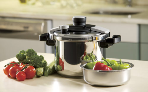 pressure cooker and vegetables sitting on a kitchen countertop