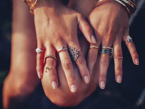 hand-wearing-multiple-pieces-of-jewelry-like-rings-and-bracelets