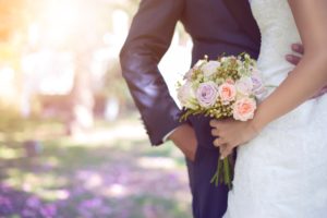 cropped-bride-and-groom-with-bouquet