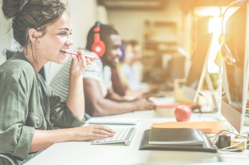 woman-blogging-for-businesses-at desk-next-to-male