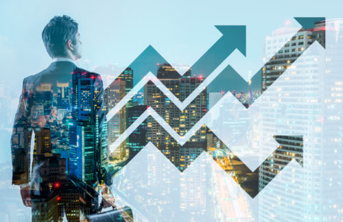 Man-looking-towards-city-skyling-in-anticipation-with-arrows-in-graph-form-digitally-overlay-for-upcoming-improvements