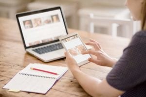 woman viewing content on tablet and laptop